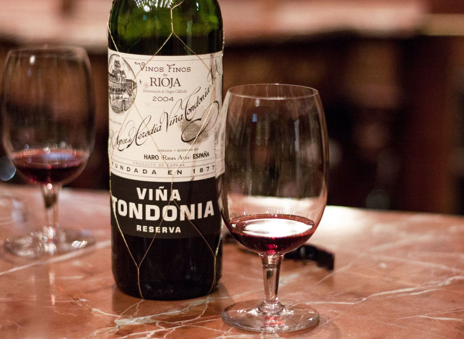 Viña Tondonia Reserva wine with glasses on a marble counter in Rioja, Spain.