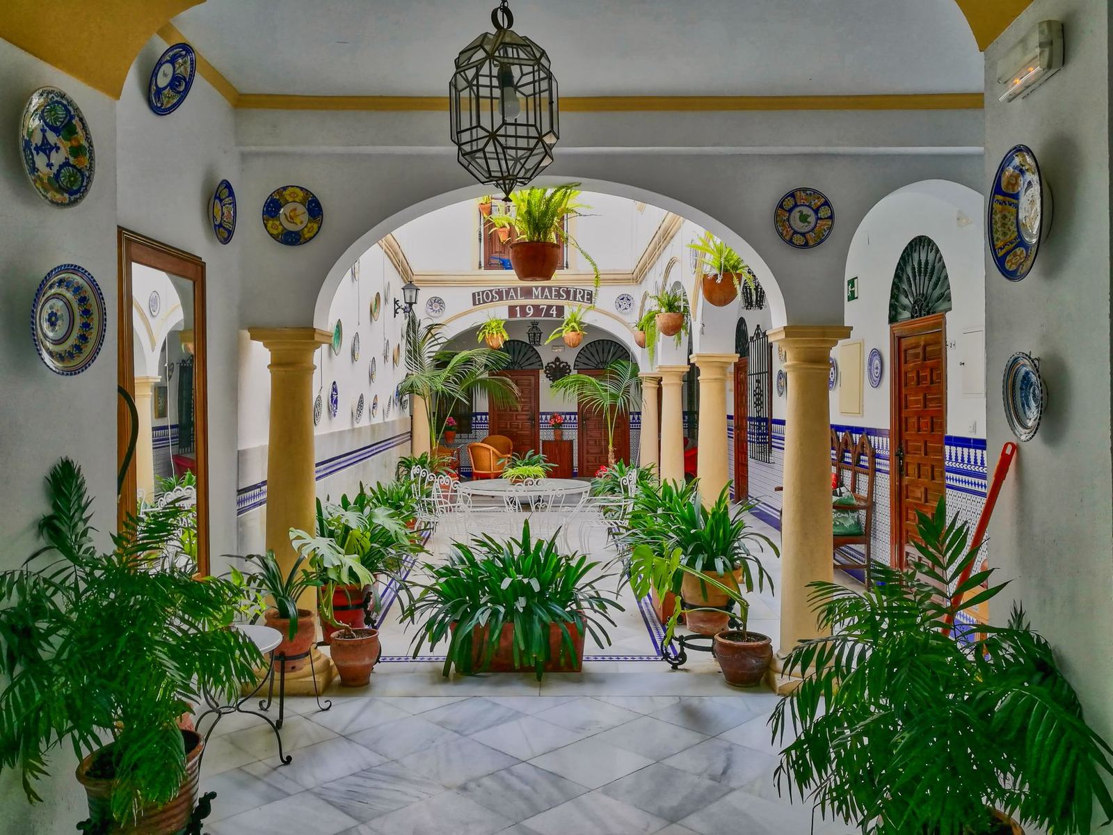 Charming Andalusian courtyard with lush plants in Cordova, Spain, capturing traditional Spanish architecture.